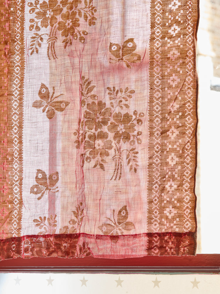 A pair of vintage red patterned voile curtains