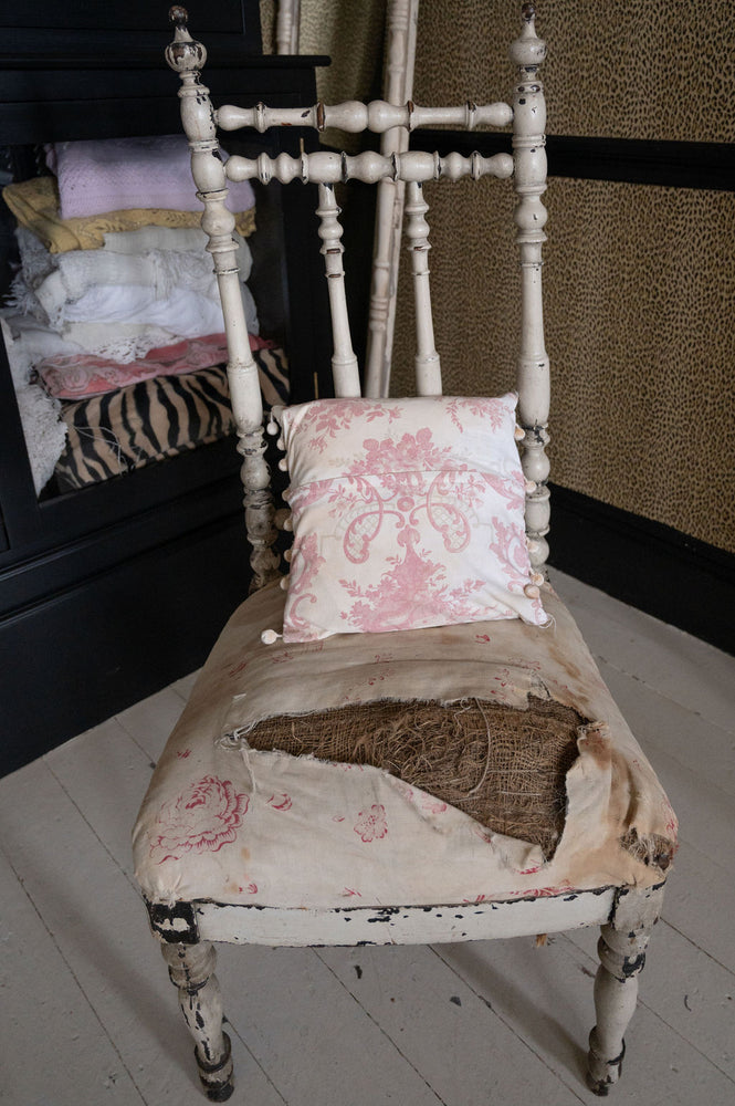 Antique pink floral cushion with pom poms