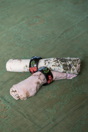 A pair of Black floral wooden napkin rings