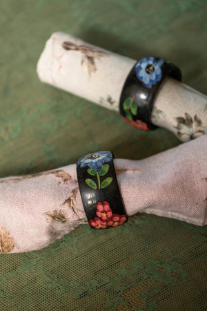 A pair of Black floral wooden napkin rings