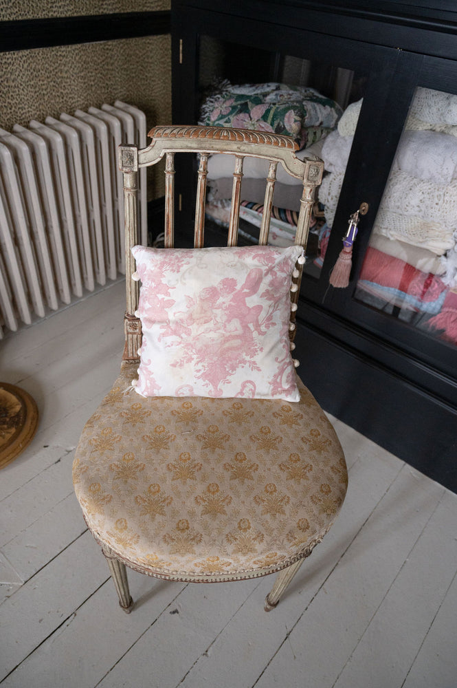 Antique pink floral cushion with pom poms