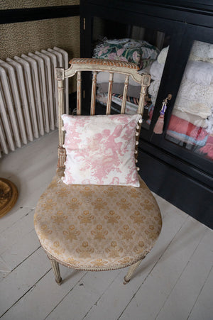 Antique pink floral cushion with pom poms