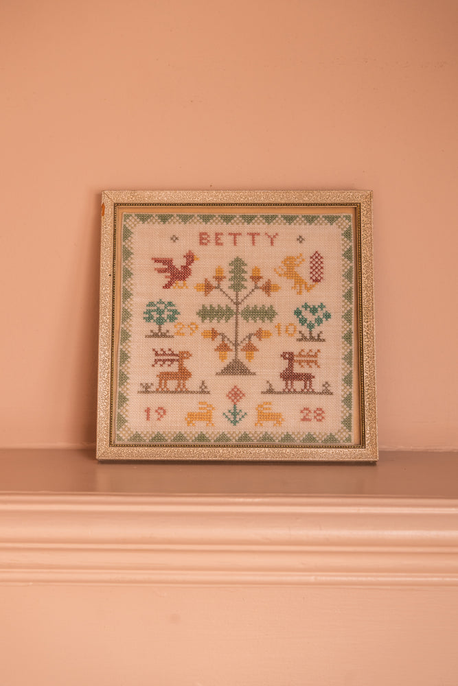 Antique tapestry in a white frame