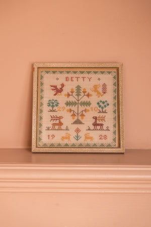Antique tapestry in a white frame