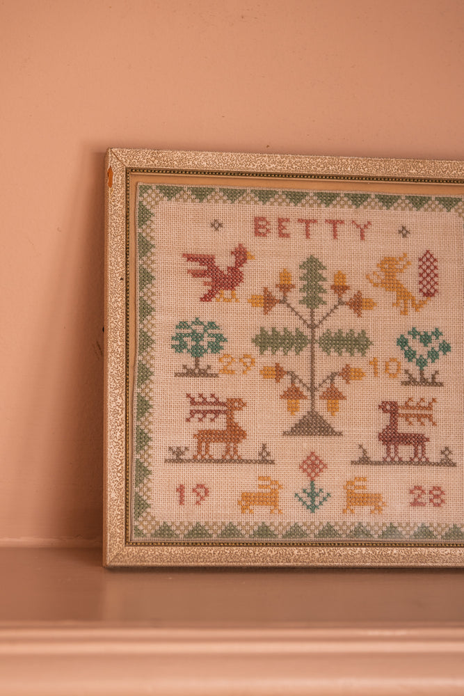 Antique tapestry in a white frame