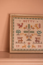Antique tapestry in a white frame