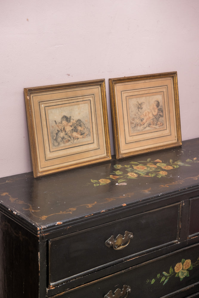 Antique pair of cherub paintings in gold frames