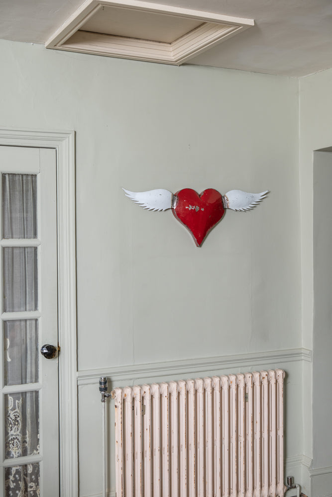 Vintage red metal heart with wings