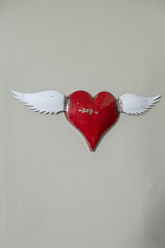 Vintage red metal heart with wings