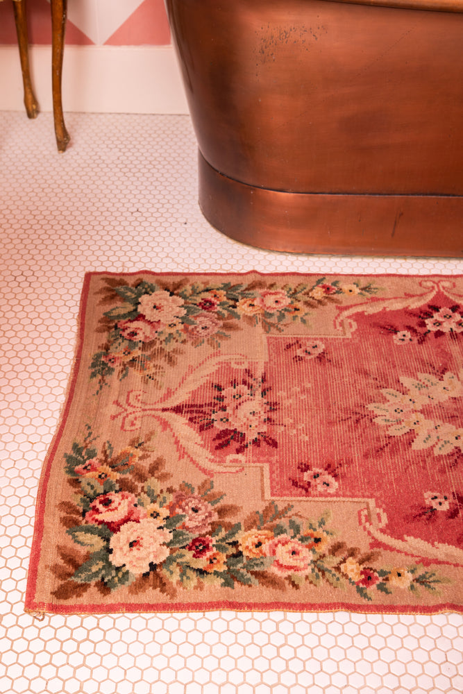 Antique pink floral rug