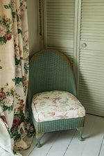 Sweet antique Lloyd loom wicker chair with floral seat