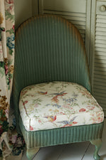 Sweet antique Lloyd loom wicker chair with floral seat