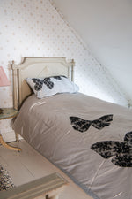 Grey silk duvet cover with black lace butterflies