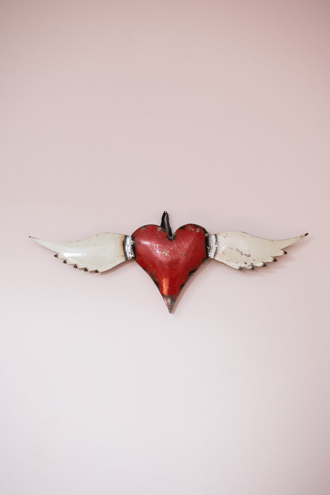 Vintage small red metal heart with wings