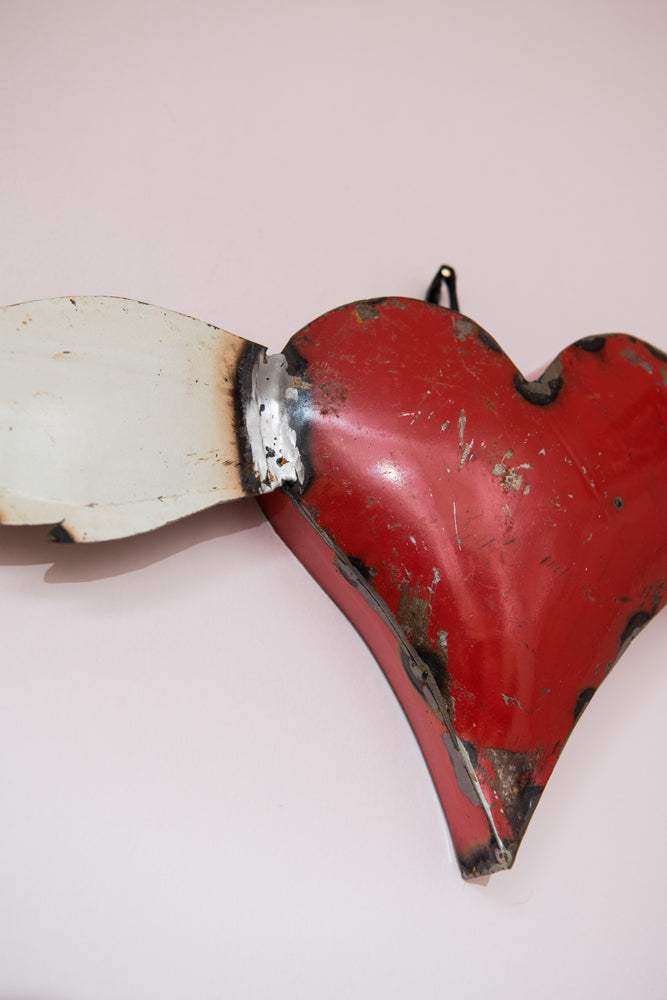 Vintage small red metal heart with wings